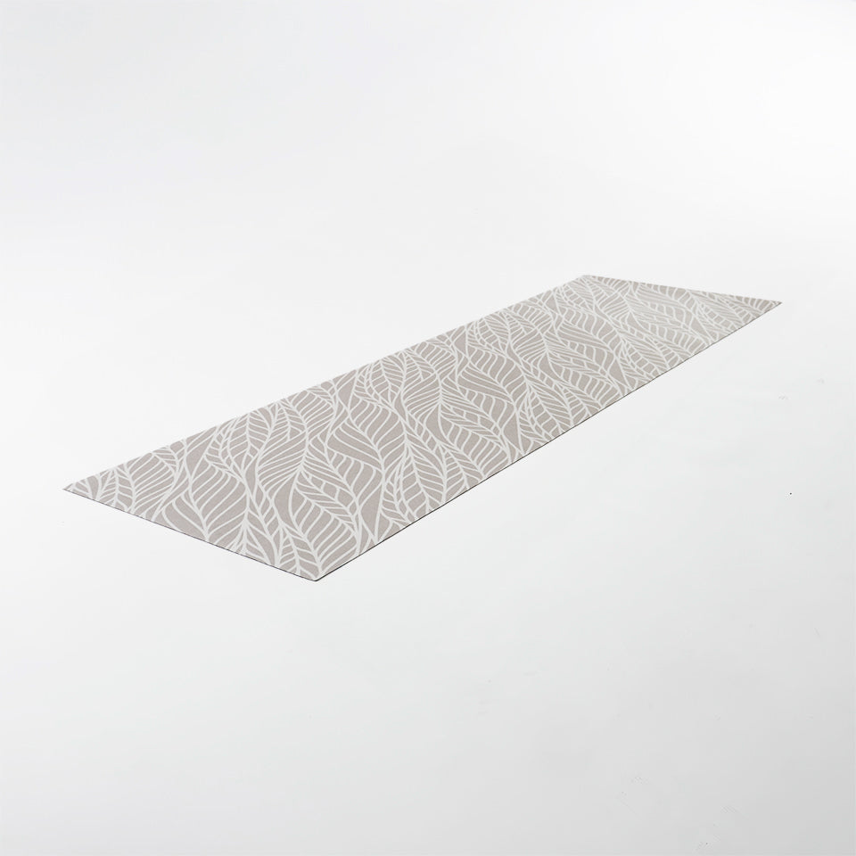 Overhead angled shot of runner Abstract cream colored leaf pattern on shiitake tan linen look low profile washable floormat