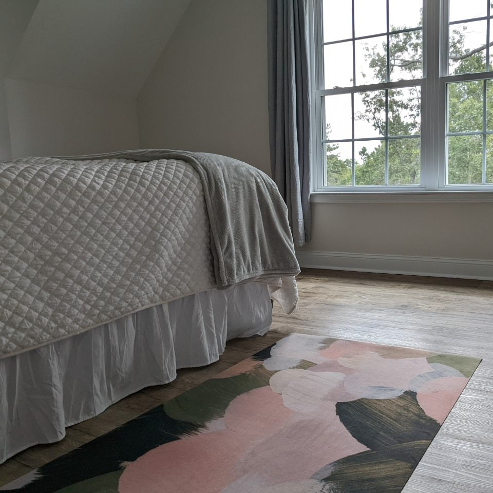 Beautiful low-profile rubber backed accent rug placed beside a bed and used as a bedside runner rug.