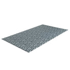 Angle shot of Coastal blues in an organic waved pattern on a washable low profile indoor floor mat