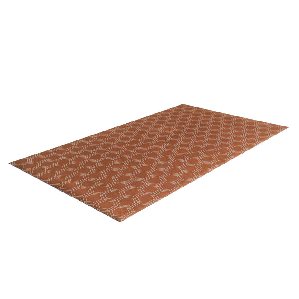Overhead angle shot of Low profile washable floor mat in burnt orange linen look with double honeycomb accent design in shiitake tan