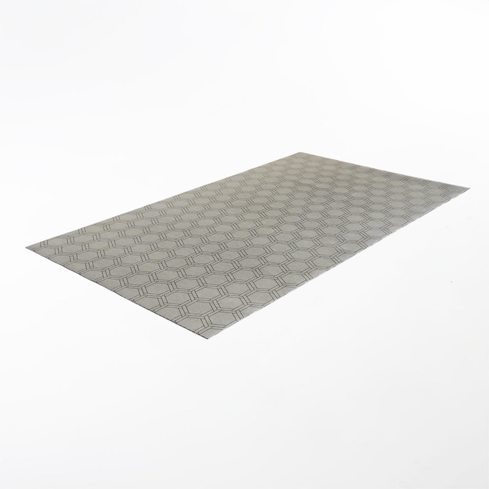 Angled overhead shot of Low profile washable floor mat in shiitake tan printed linen with double honeycomb accent design in urbane bronze