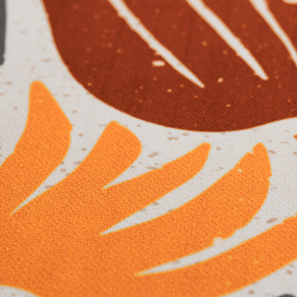 Close up of MCM funky abstract floral with shiitake tan background and orange and yellow retro flowers with green leaves on low profile washable floor mat
