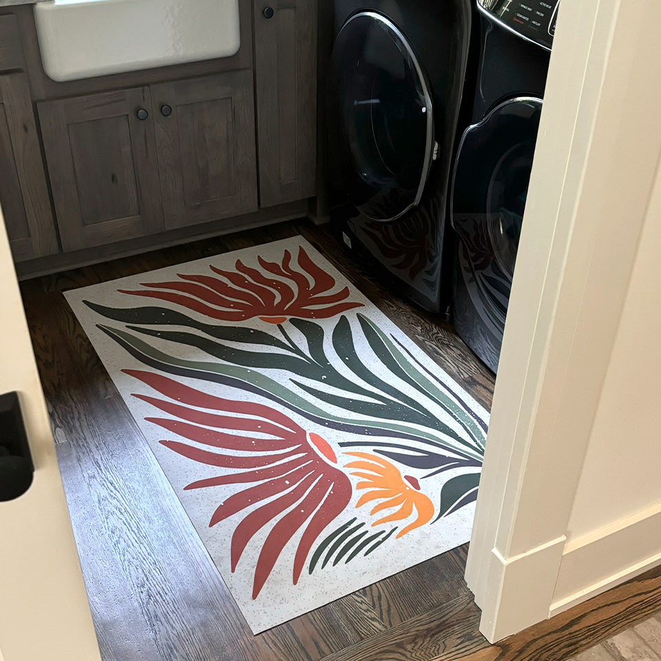 Dreamy MCM Flower in earthen jug fitting perfectly in a laundry room in front the washer, dryer, and sink