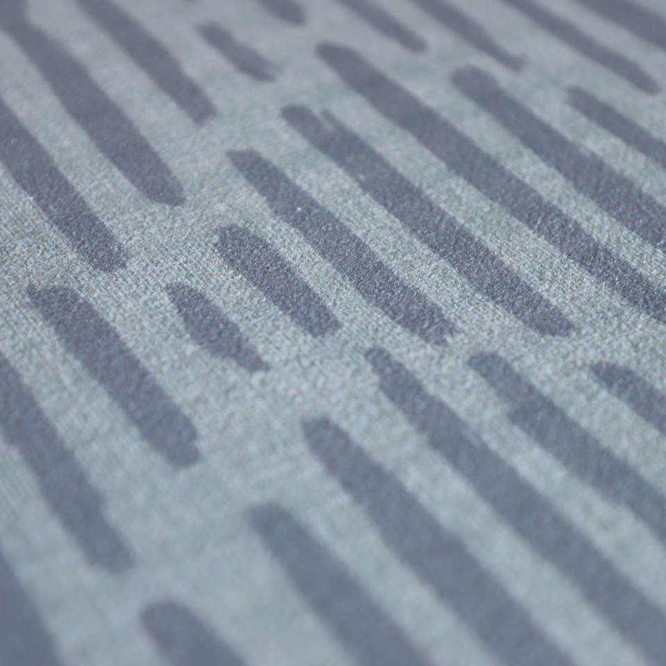 Close up of Storm cloud grey blue organic line abstract design on sea salt blue background printed on a thin low profile machine washable floor mat for indoor use.