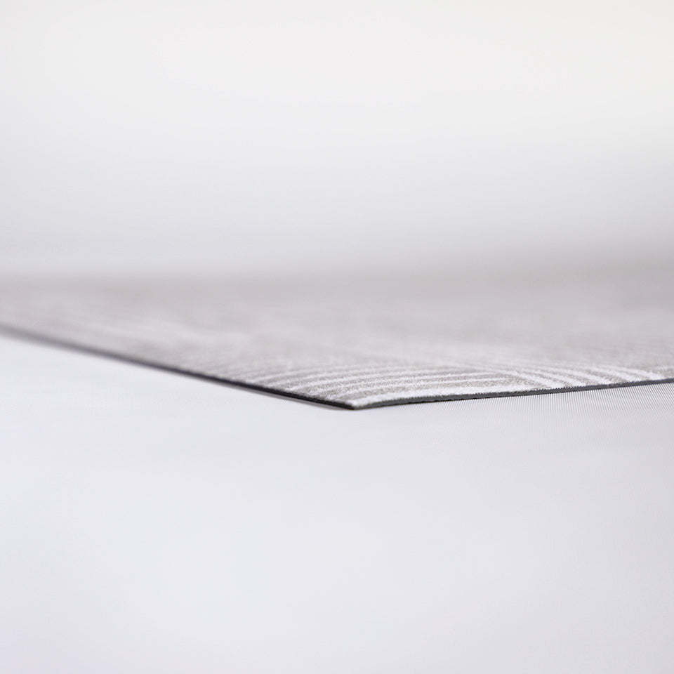 Super low profile view of Shiitake tan background with snowbound cream colored organic lines in abstract square pattern on a low profile washable interior floor mat.