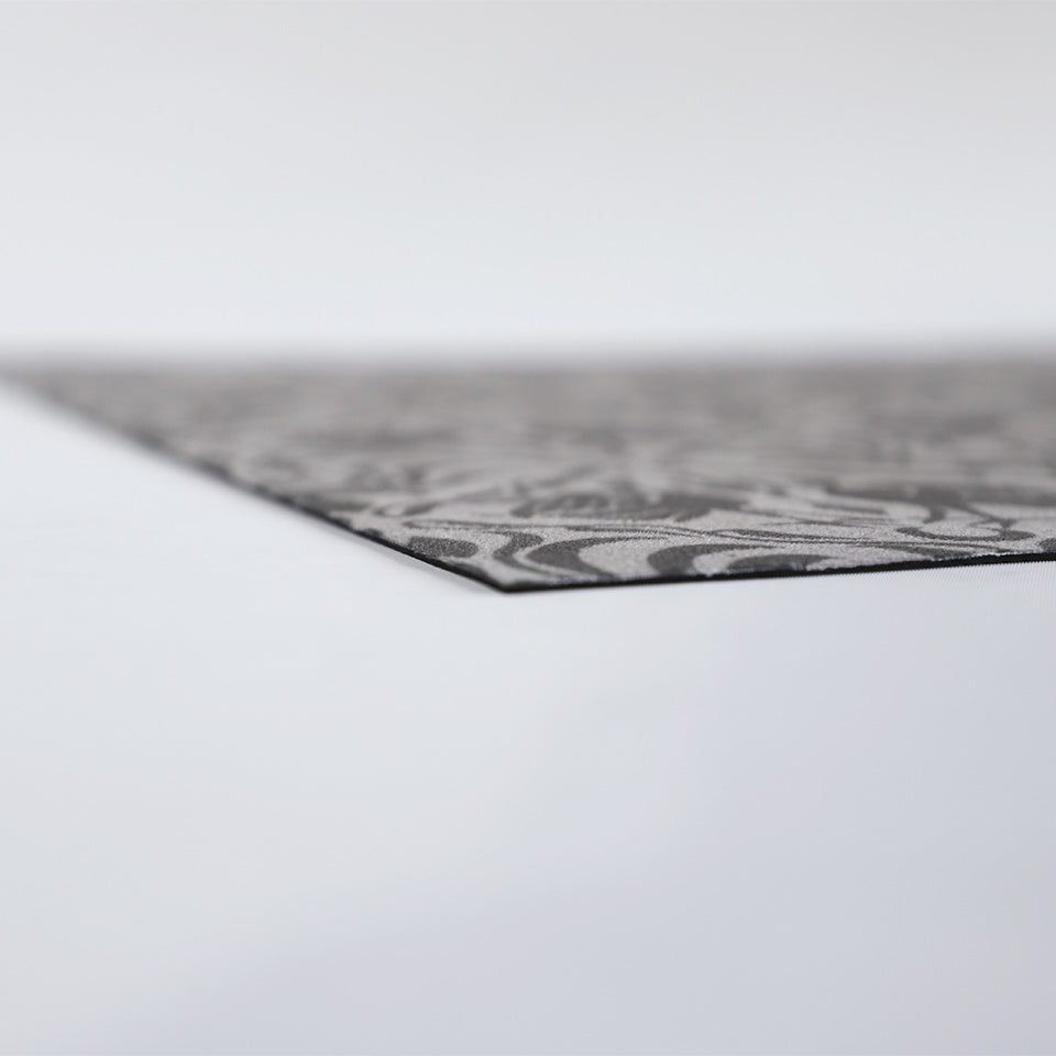 Low profile shot of Urbane bronze ornamental cranes in a vintage damask looking pattern printed on shiitake tan background on a washable low profile indoor floor mat