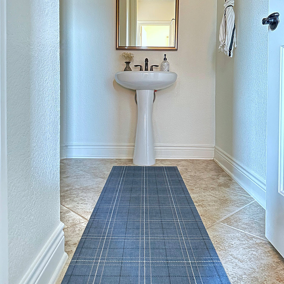 Low-profile Un-Rug Oslo Plaid runner mat perfectly fitted in front of a bathroom sink.