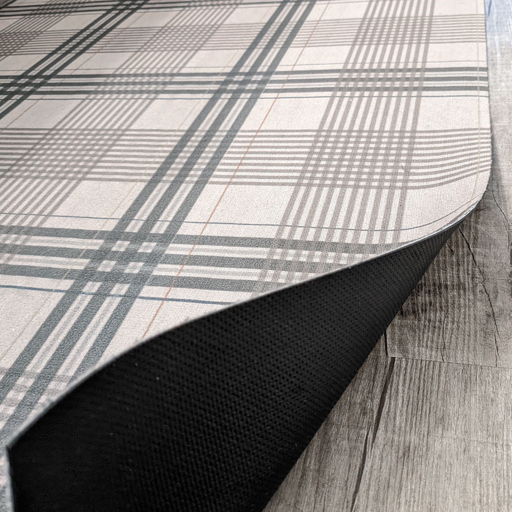 Flipped corner of Low-Pile Un-Rug decorative accent rug in Oxford Plaid with flipped up corner to showcase the durable rubber backing.