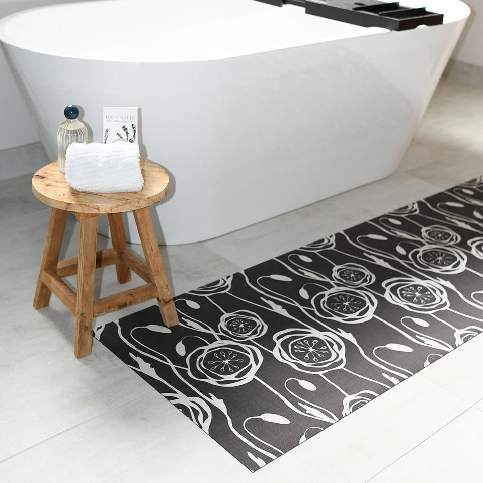 Low-Profile Un-Rug floral Peonies design placed next to a bathtub for its soft surface and machine washable quality.