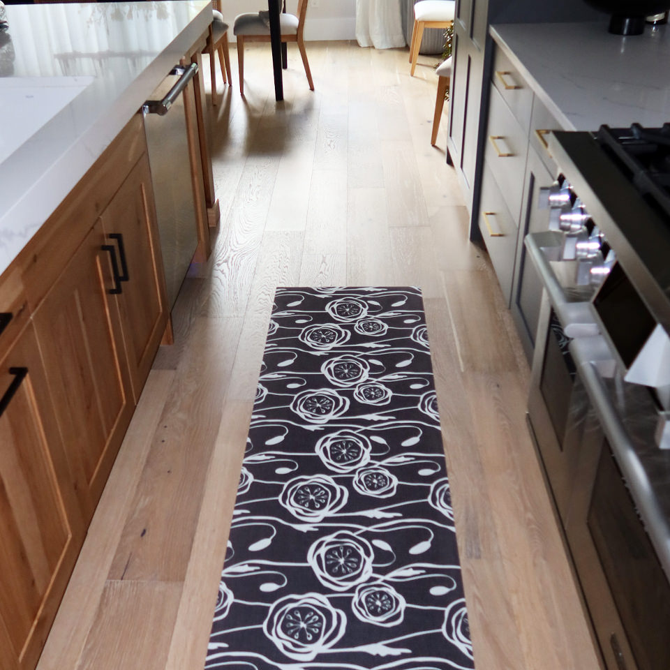 Un-Rug Peonies low-profile runner mat fitting perfectly in a kitchen space .