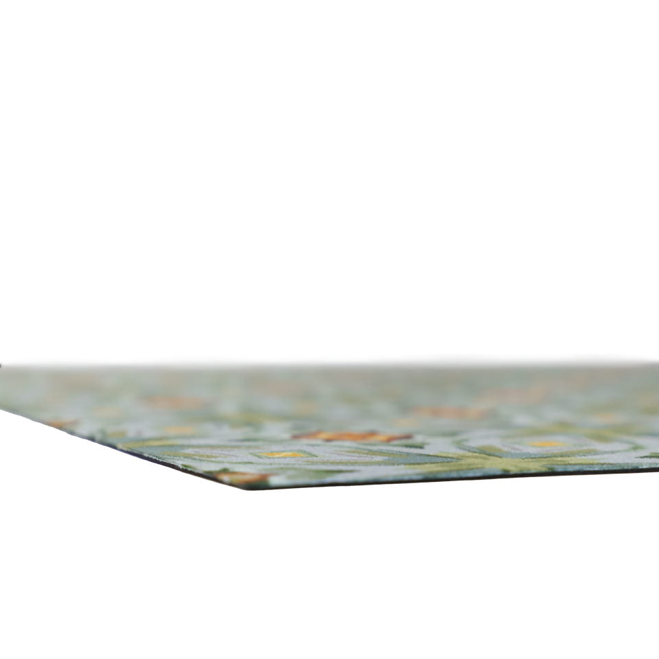 Super low profile shot of Neutral kaleidoscope pattern in aquas, apple green, and hints of orange on this low profile washable interior floor mat.