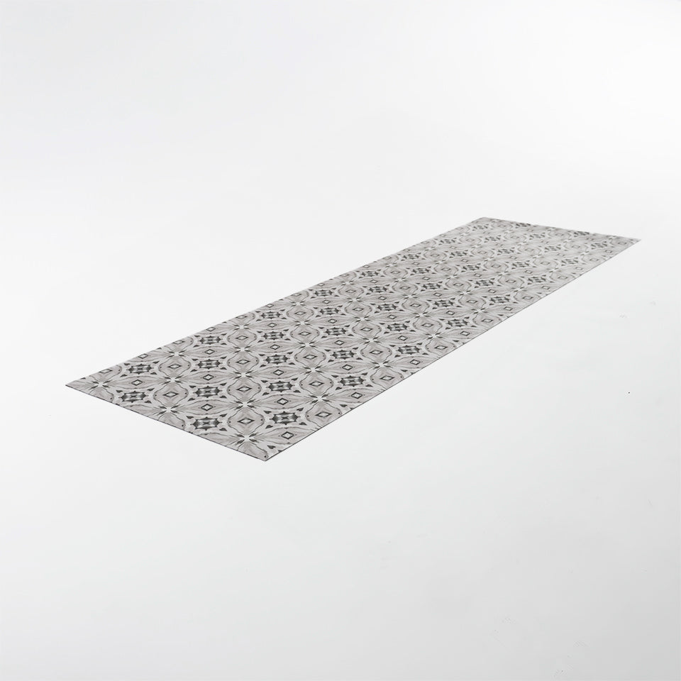 Neutral kaleidoscope pattern in shiitake tan and urbane bronze brown with touches of storm cloud blue on this low profile washable interior floor mat.