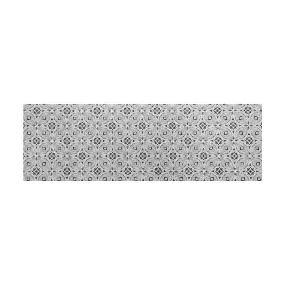 Overhead shot of kitchen runner sized floor mat  in a neutral kaleidoscope pattern.  Colors in shiitake tan and urbane bronze brown with touches of storm cloud blue