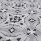 Close up of Neutral kaleidoscope pattern in shiitake tan and urbane bronze brown with touches of storm cloud blue on this low profile washable interior floor mat.