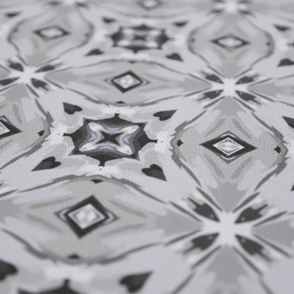 Close up of Neutral kaleidoscope pattern in shiitake tan and urbane bronze brown with touches of storm cloud blue on this low profile washable interior floor mat.