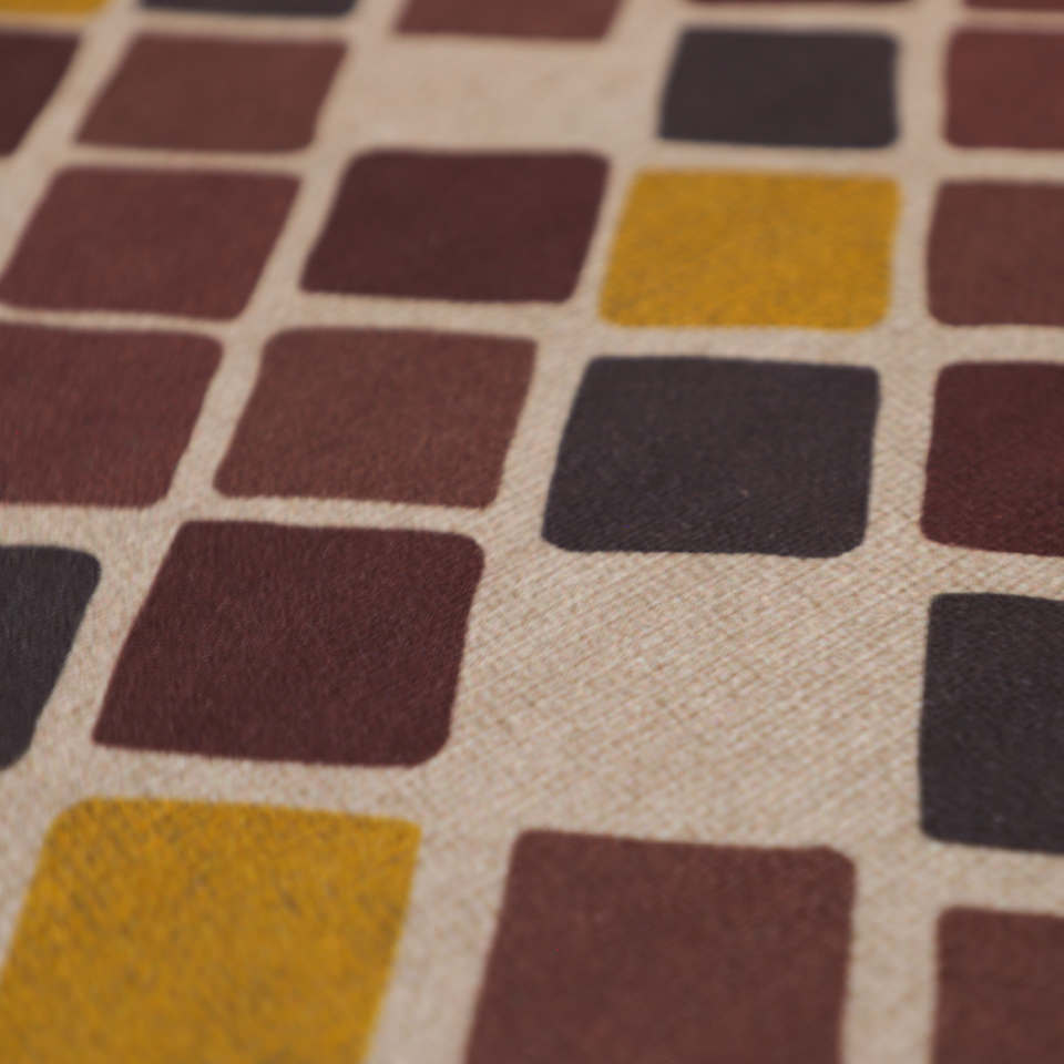 close up of fabric surface with multiple squares with rounded edges, in dark reds. browns, and yellows