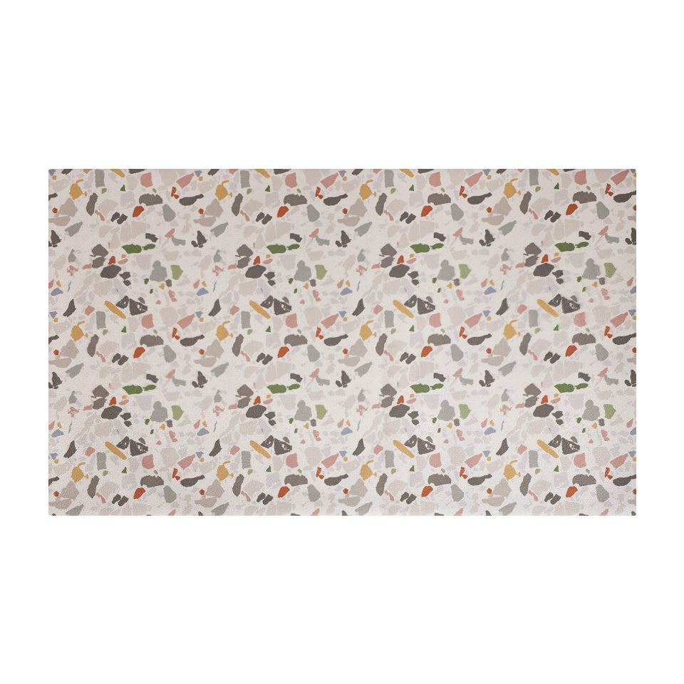 overhead view of rectangular mat with light neutral background and terazzo pattern in multi colors