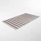 rectangular mat with light and dark neutral colored vertical stripes