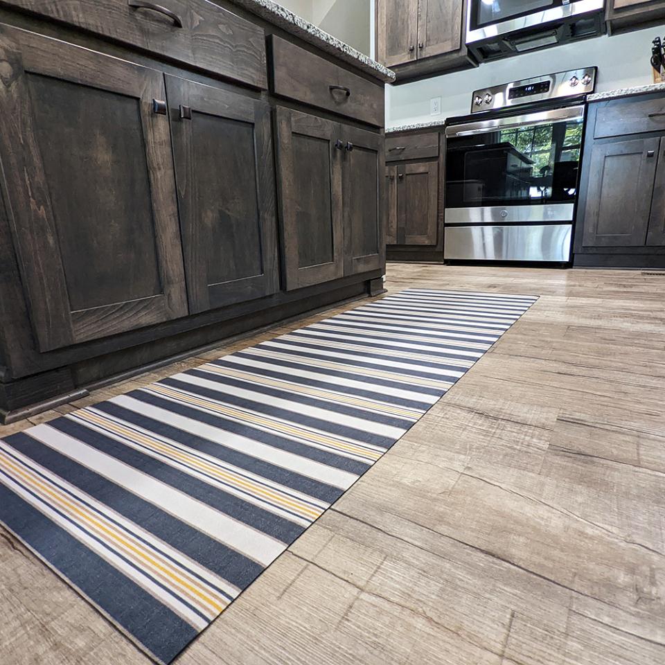 Ticking stripes in navy blue storm cloud with mustard yellow tassel stripes on an indoor washable kitchen runner
