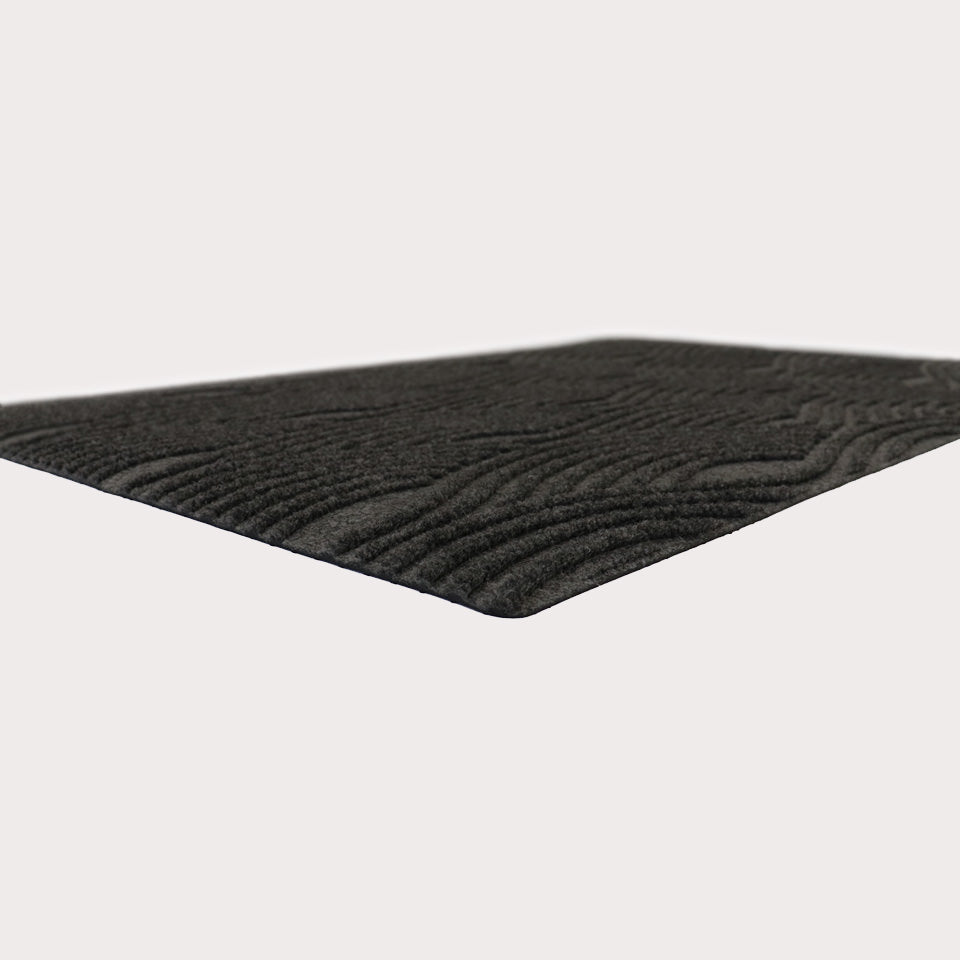 Angular shot of Waves in graphite showing the bi-level surface and low-profile.