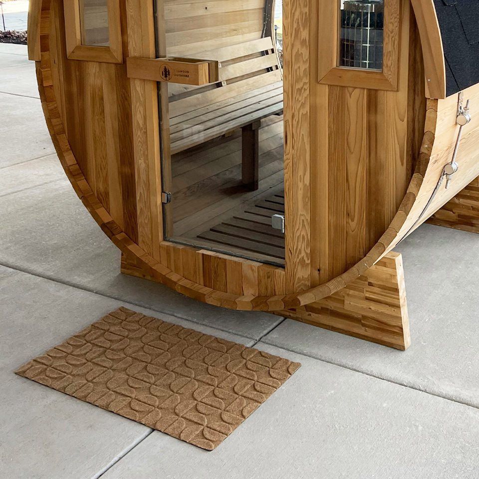WaterHog Luxe Hourglass in wheat located outside in front of a sauna because it is all-weather.