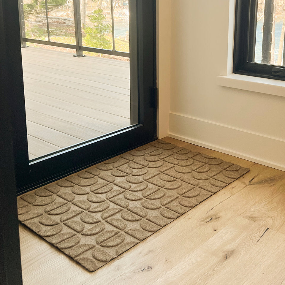 WaterHog Luxe Hourglass doormat located inside off a deck door with a low-profile.