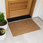 A WaterHog Luxe all-weather, low-profile mat in the color wheat located at the entrance of a home.