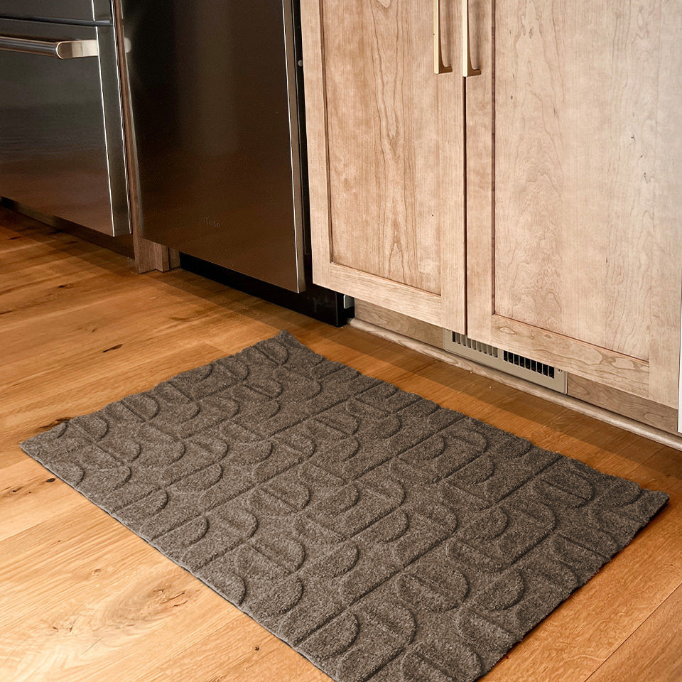 WaterHog Luxe Hourglass design in the color greige protecting a kitchen floor.