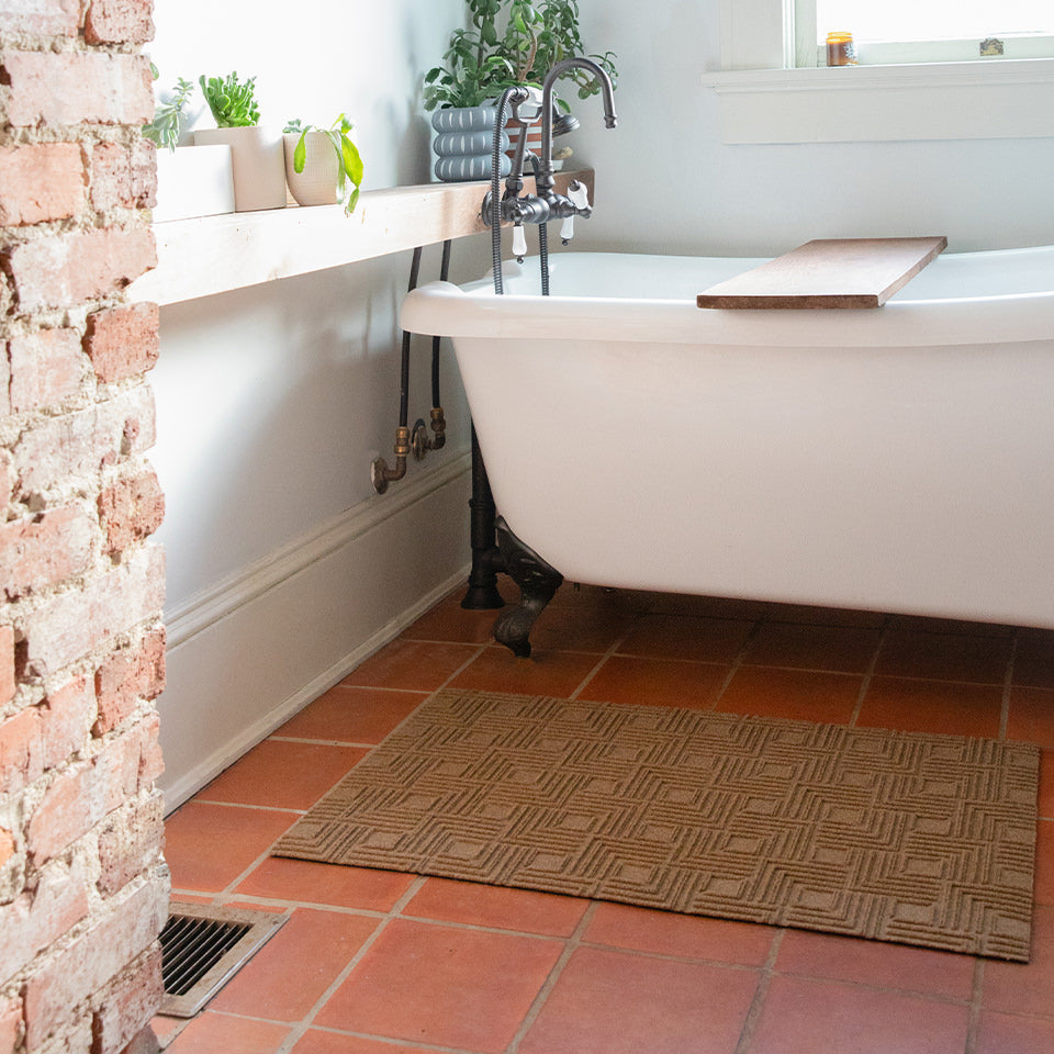 WaterHog Luxe Labyrinth in a bathroom protecting the tile floors.