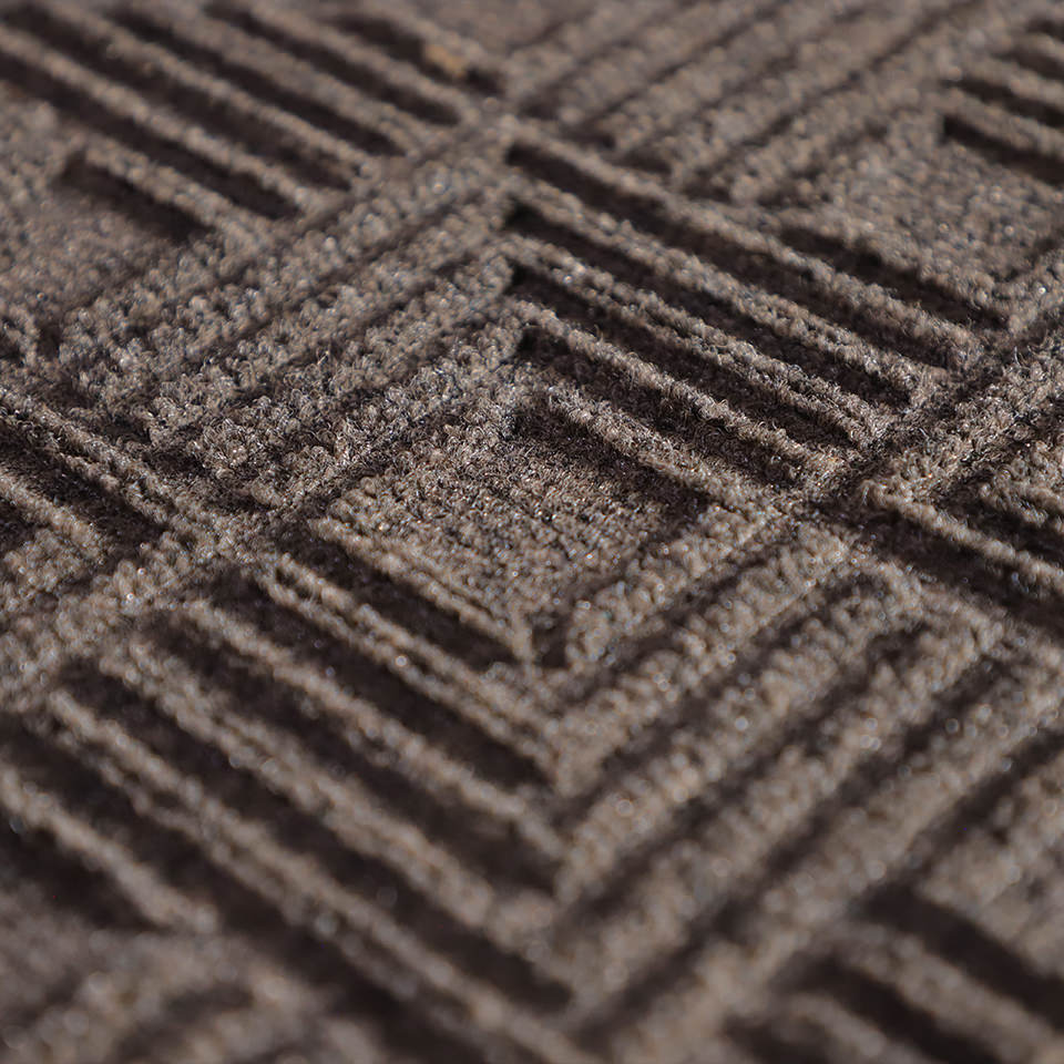 Up close, detailed image of Labyrinth’s surface, capturing the complex linear design carved out by the bi-level surface, shown in greige.