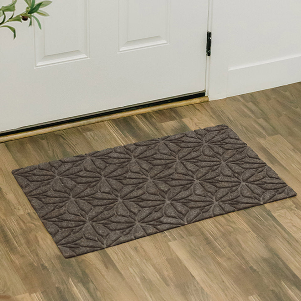 Beautiful all-weather WaterHog Luxe Magnolia Single Door Doormat placed just inside the front door.