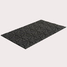 Angled image of the single-door Magnolia mat in the color graphite on a creamy white background.