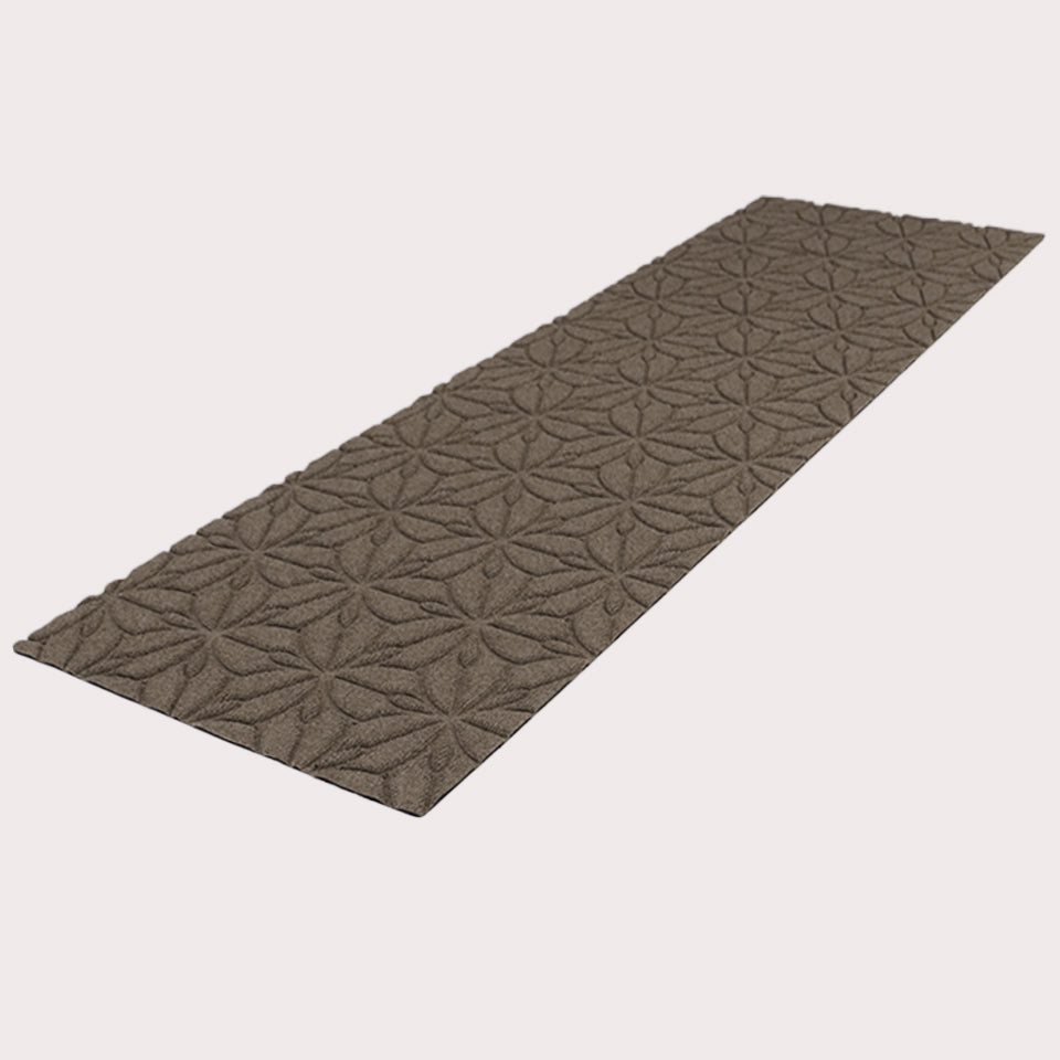 Angled image of the double-door Magnolia mat in the color greige on a creamy white background.