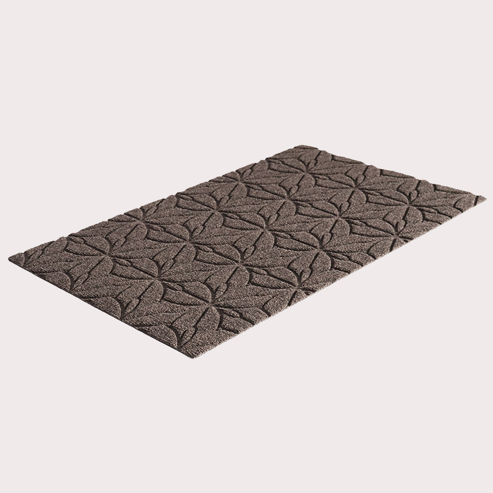 Angled image of the single-door Magnolia mat in the color greige on a creamy white background.