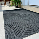 Close up surface shot of the stain-resistant and eco friendly WaterHog Luxe Put Your Records On large doormat in the color graphite.