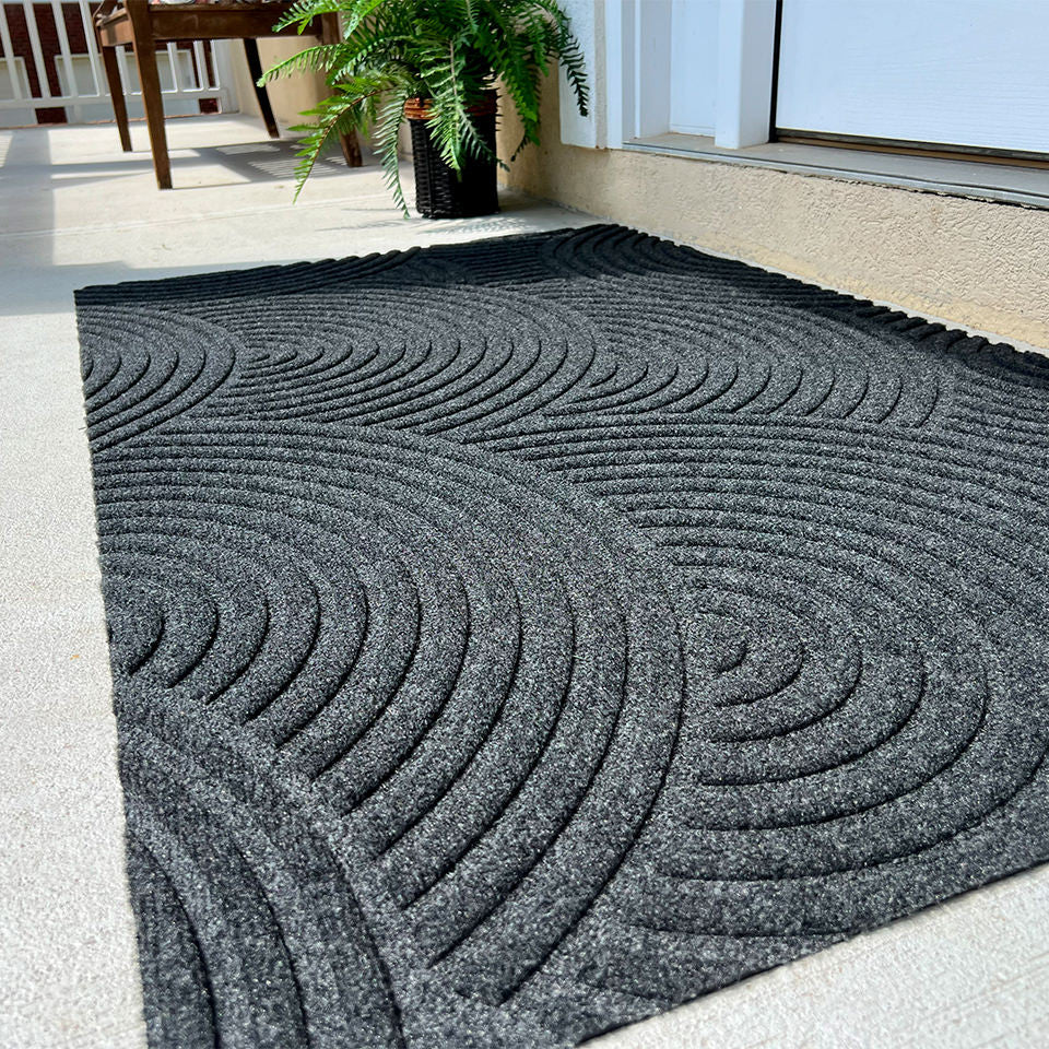 Close up surface shot of the stain-resistant and eco friendly WaterHog Luxe Put Your Records On large doormat in the color graphite.