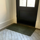 Olive Put Your Records On single door all-weather mat at the side entrance of a home