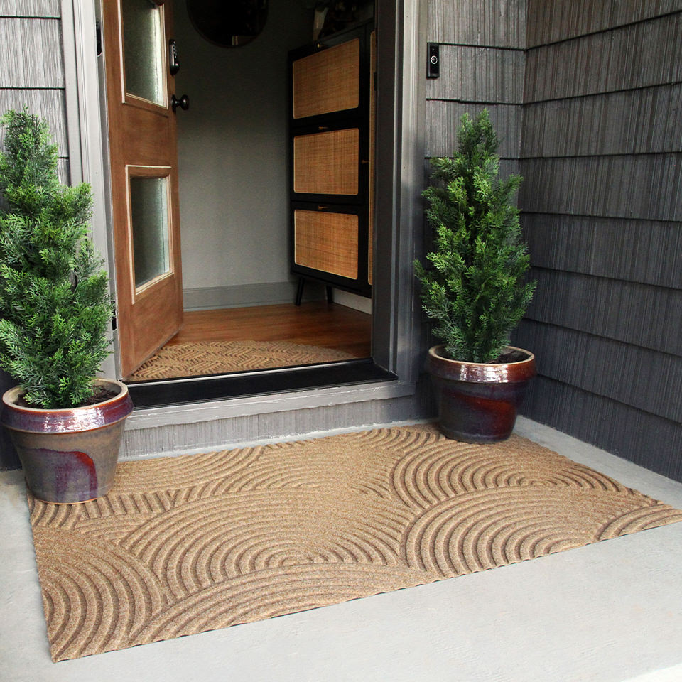 3'x5' WaterHog Luxe all-weather doormat shown in the Put Your Records On design in wheat color placed at a mid-century modern front door.