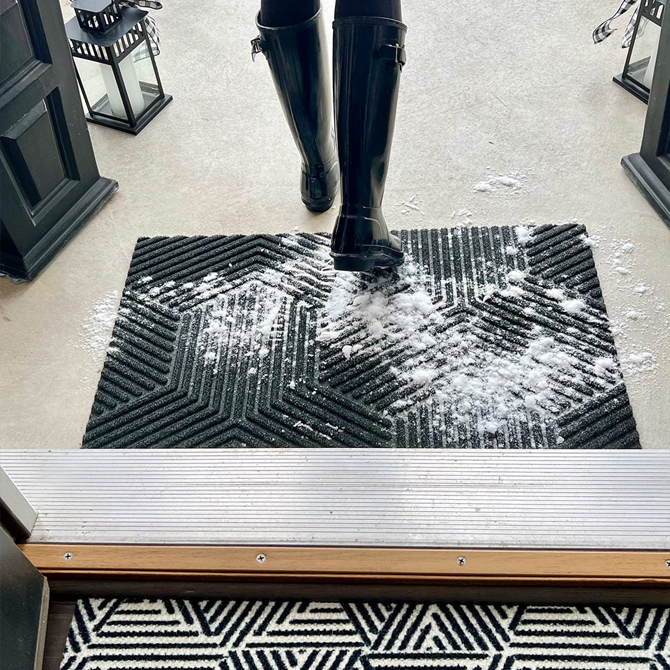WaterHog Luxe Zephry graphite doormat at front door stopping the snow from coming inside.