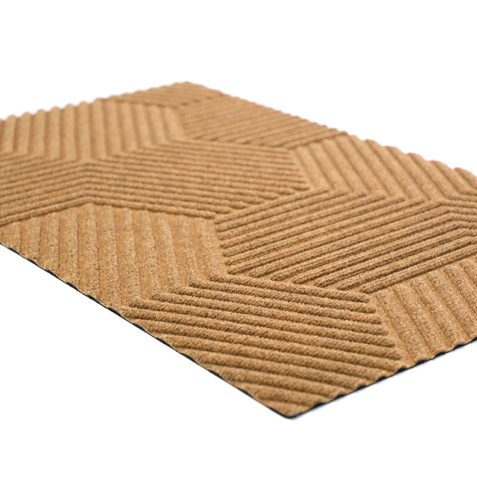 Angle shot of zephyr geometric doormat in wheat color.  Part of our all weather fade resistant doormat collection.