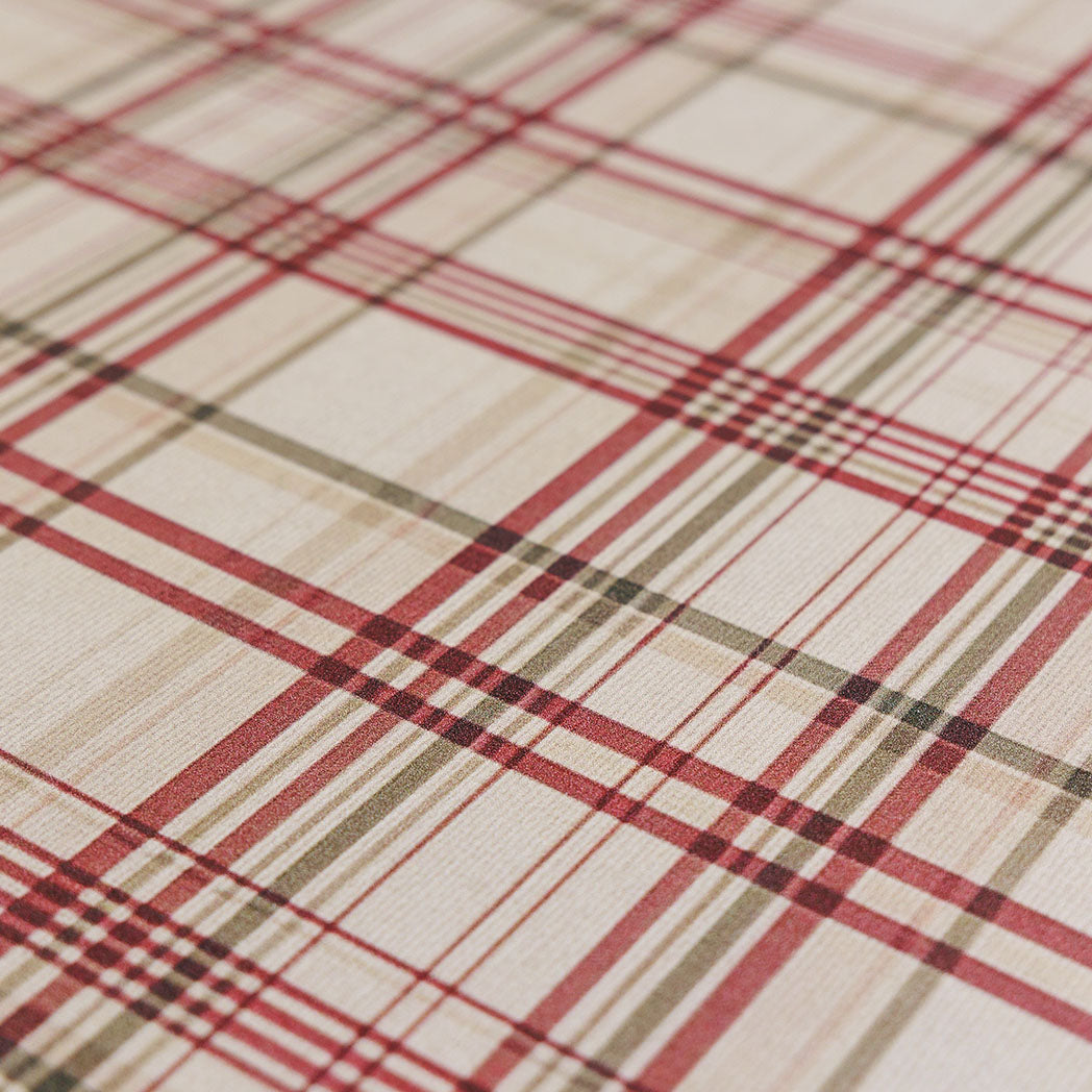 Close-up of a red, green, and beige plaid design on Happy Feet's wipeable surface
