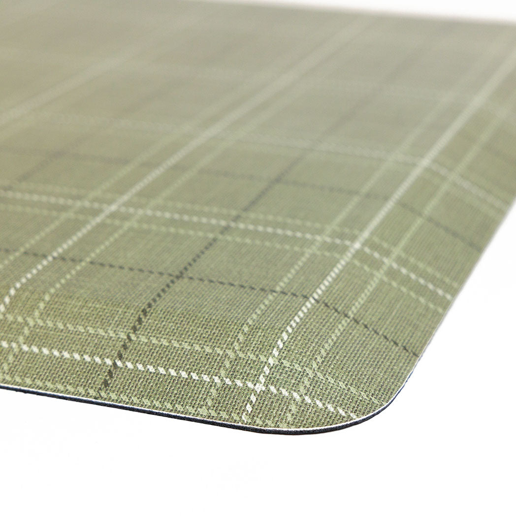Corner detail of classic green plaid anti-fatigue kitchen mat with wipeable surface and neutral design for kitchen comfort.