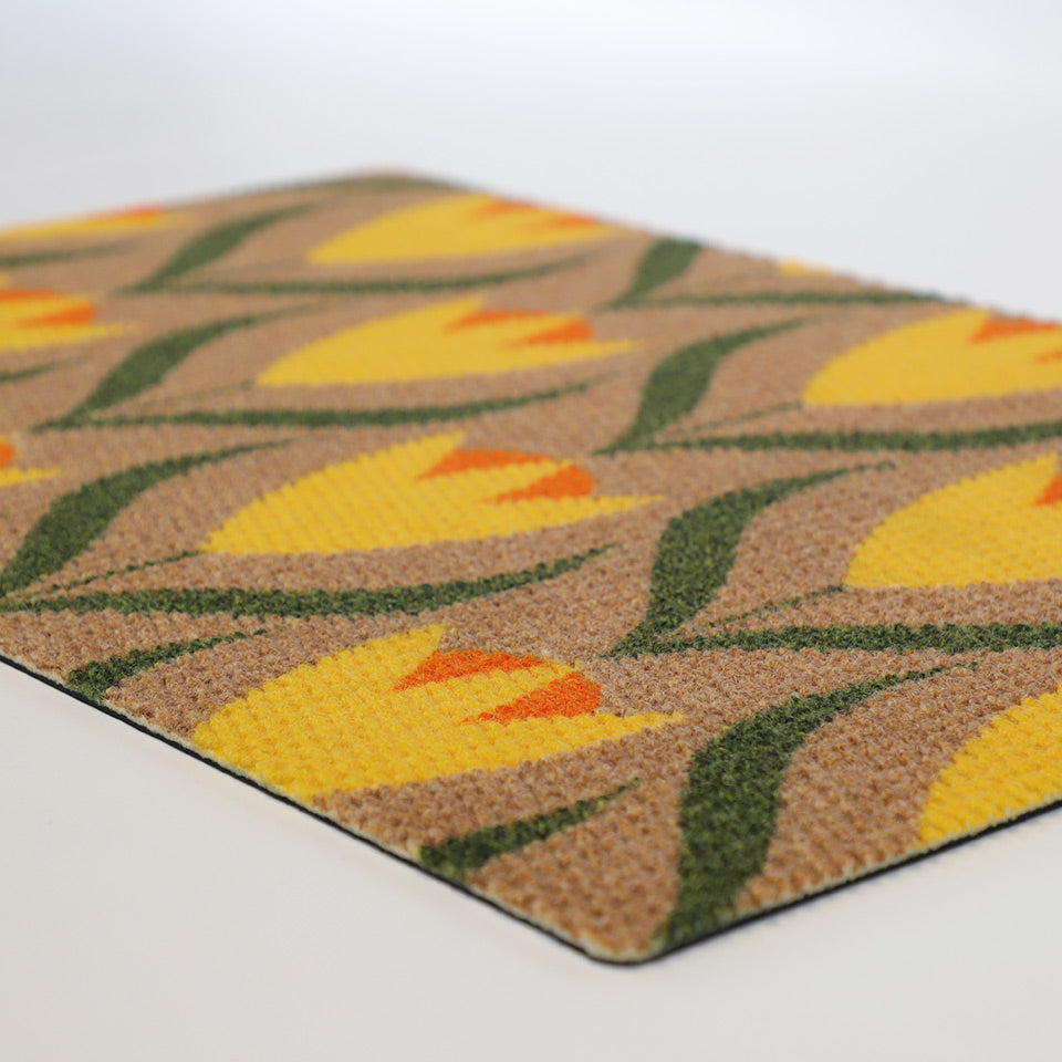 close up of coir and yellow Buttercups doormat laying flat on white floor