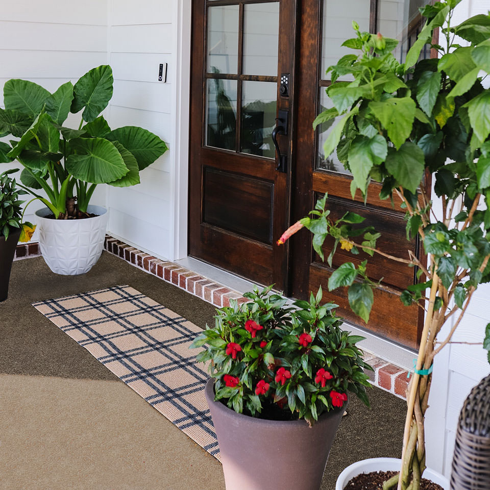 double door size coir and black classic plaid doormat in front of double doors
