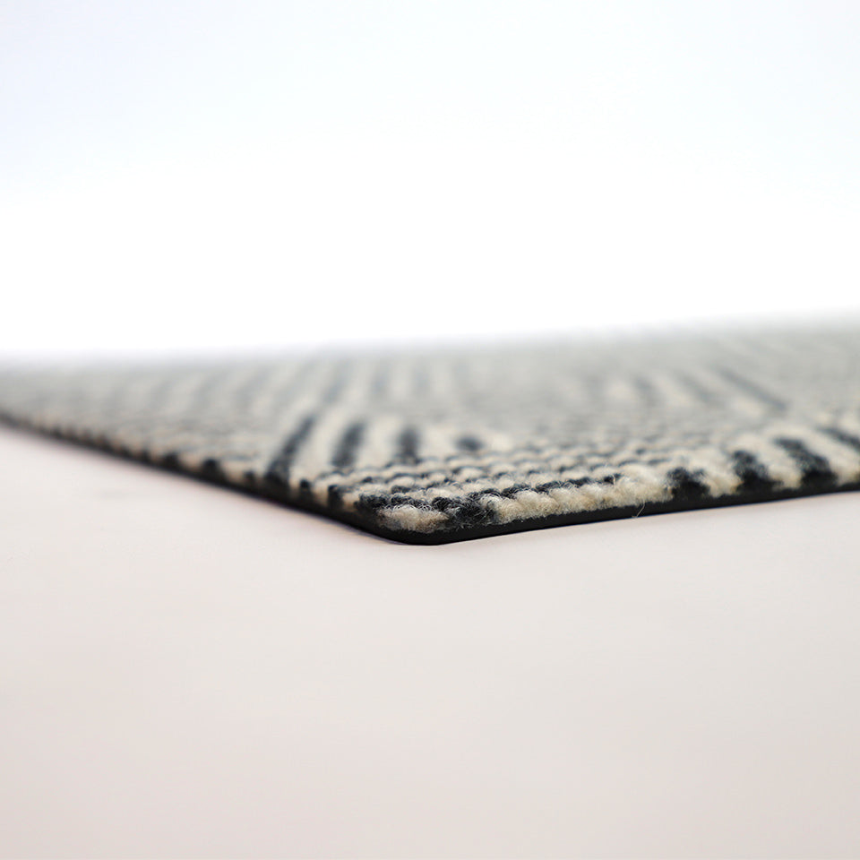 Chic doormat featuring a modern black and white geometric pattern; the Escher door mat is a low-profile doormat that looks great at any front door.