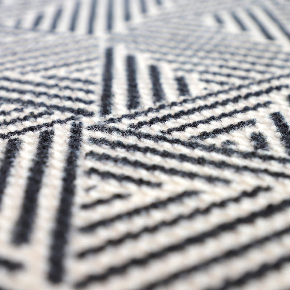 Stain resistant doormat that features a modern black and white doormat pattern made from recycled materials; the Escher indoor/outdoor doormat will not shed or smell like coir mats.