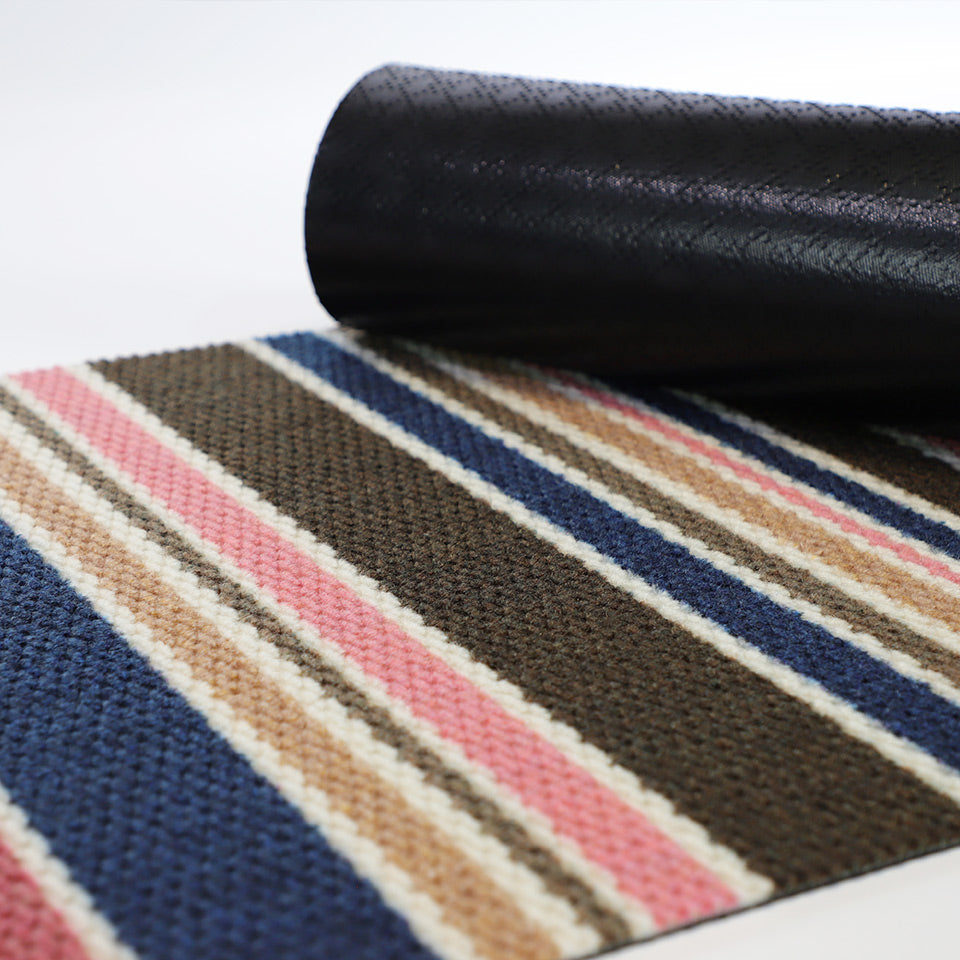 Rubber backing of doormat on striped pink brown and navy retro feeling doormat