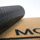 Close up of rubber backing on personalized tan and black doormat customized with last name