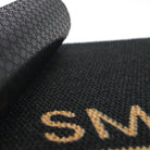 Close up of rubber backing on personalized doormat in black and tan