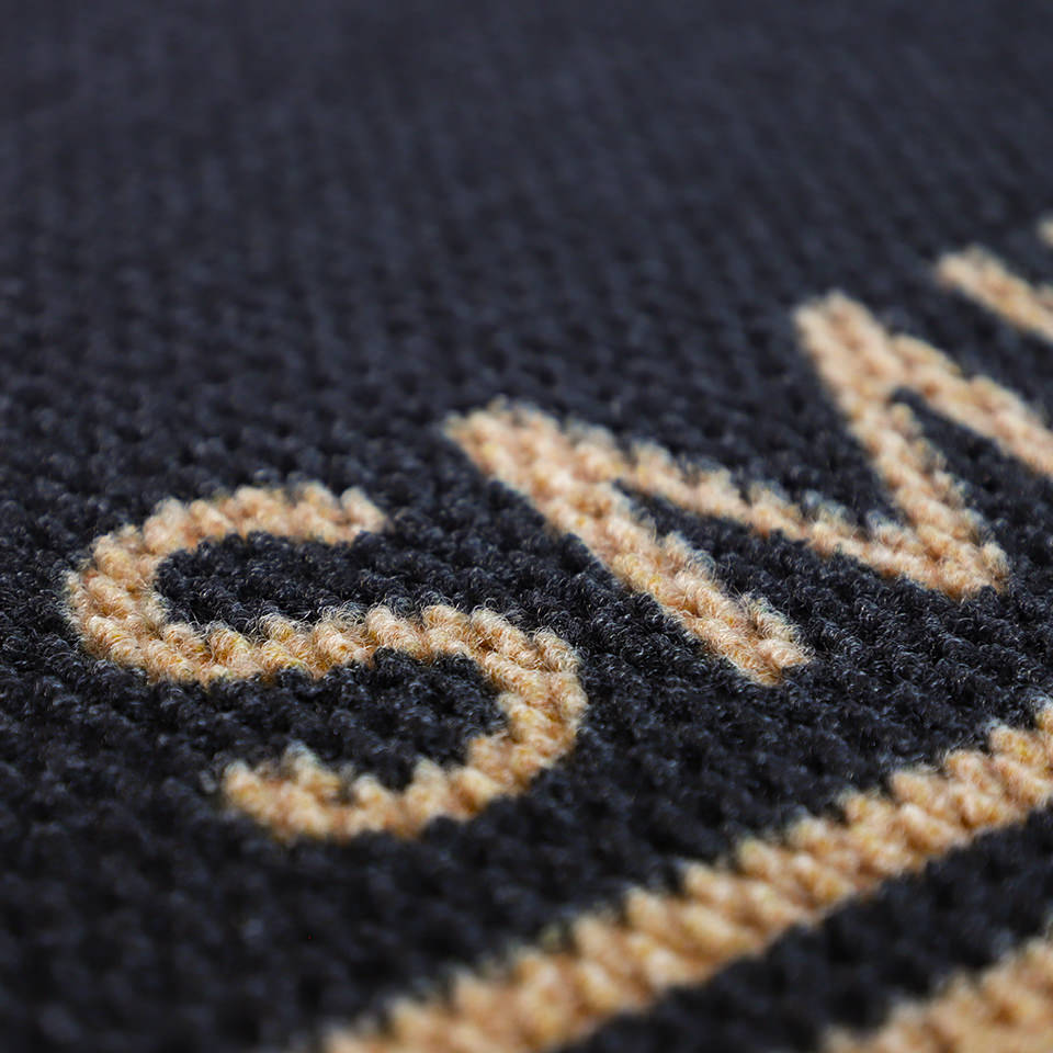 Close up of non shedding doormat personalized with last name